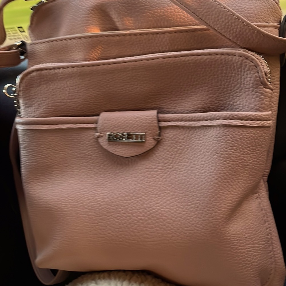 A rose gold Rossetti purse it a mid side could fit on a kid -woman